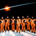 Seven astronauts wearing their partial pressure launch and entry suits, pose for traditional portrait. 