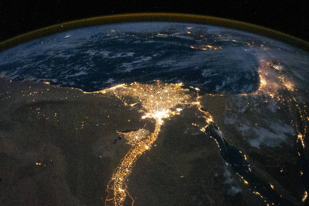Bright lights surround Nile river in nighttime image taken from Earth orbit 