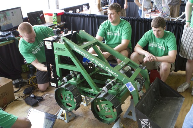 A university team prepares their remote-controlled excavator, called a Lunabot, for competition