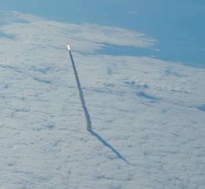 Photographed from a shuttle training aircraft, space shuttle Endeavour and its six-member STS-134 crew head toward Earth orbit and a rendezvous with the International Space Station.