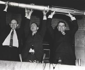 Dr. James Pickering, Dr. James van Allen and Dr. Wernher von Braun triumphantly display a model of the Explorer I.