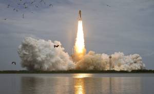 Space shuttle Atlantis lifts off from Launch Pad 39A at Kennedy Space Center, beginning STS-135, the final mission of the Space Shuttle program.