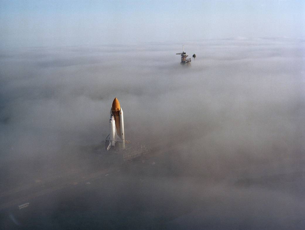 Shuttle Challenger being rolled to launch pad amid heavy fog