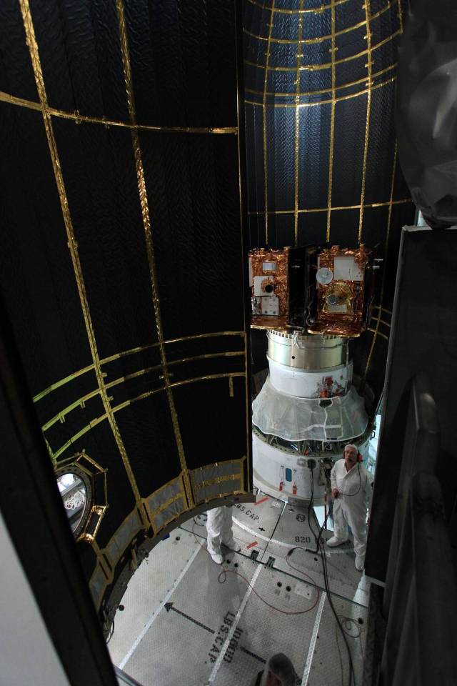 The second half of the clamshell-shaped Delta payload fairing swings into place around NASA's twin Gravity Recovery and Interior Laboratory spacecraft.
