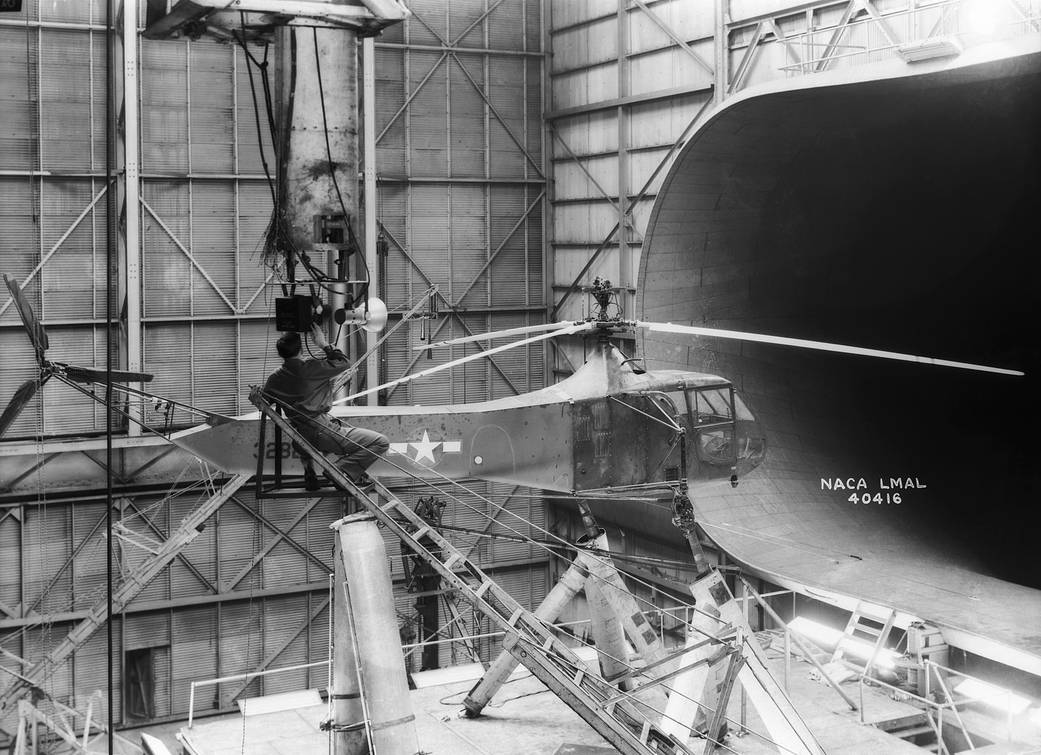 Black and white photo of the Sikorsky YR-4B/HNS-1 helicopter inside the 30x60 full scale tunnel.