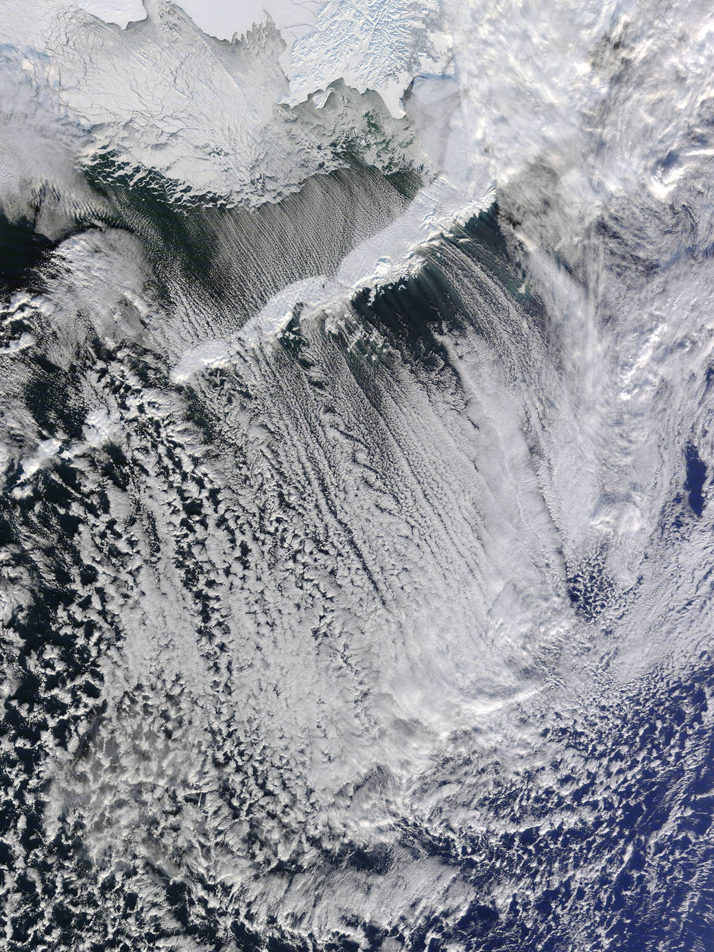 Cloud patterns in small street like shapes over water