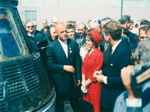 John Glenn, standing next to his Friendship 7 capsule in which he made his historic orbital flight, meets with President John F. Kennedy. Mrs. Glenn stands next to her husband. Earlier that day, President Kennedy presented the NASA Distinguished Service Award to Glenn.