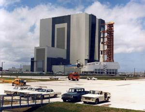 Carrying the Apollo 11 Saturn V rocket and mobile launcher, the crawler inches out of the Vehicle Assembly Building on the journey to Launch Pad 39A.