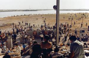 The Saturn V rocket stands on its mobile launcher at Pad 39A (center-rear, across water) as more than 3,000 news media representatives prepare for the liftoff of Apollo 11.