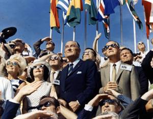 Vice President Spiro Agnew (right center) and former President Lyndon Johnson (left center) view the liftoff of Apollo 11 from the stands located at the Kennedy Space Center VIP viewing site.