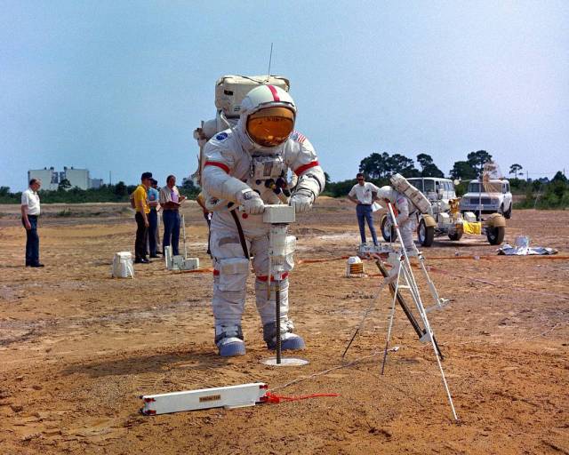Apollo 15 Commander David R. Scott operates the battery-powered lunar surface drill during a training exercise at a man-made replica of the moon's Hadley-Apennine region at the Kennedy Space Center.