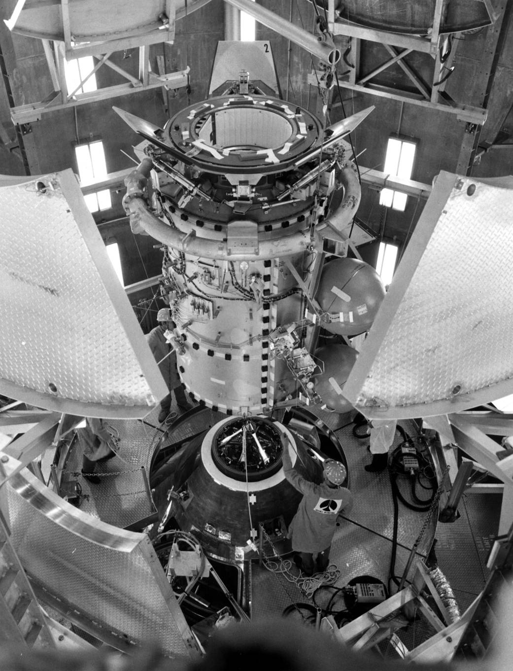 Fit checks are performed in an altitude chamber at Kennedy between the Apollo spacecraft and the docking module to be used during the Apollo-Soyuz Test Project.