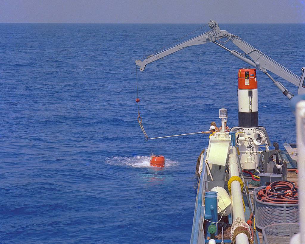 A space shuttle solid rocket booster retrieval acceptance test is conducted at sea.