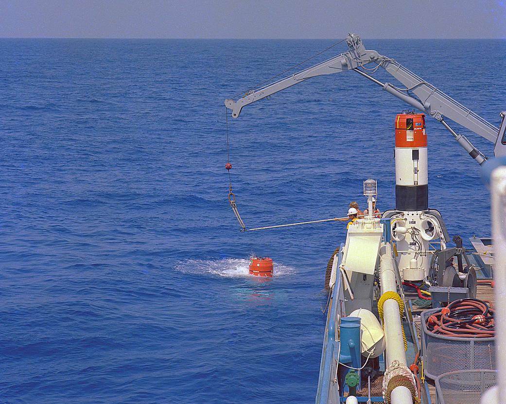 A space shuttle solid rocket booster retrieval acceptance test is conducted at sea.