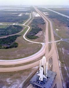 The first space shuttle destined to fly in space moves toward Pad A at Launch Complex 39, where it lifted off in April 1981.