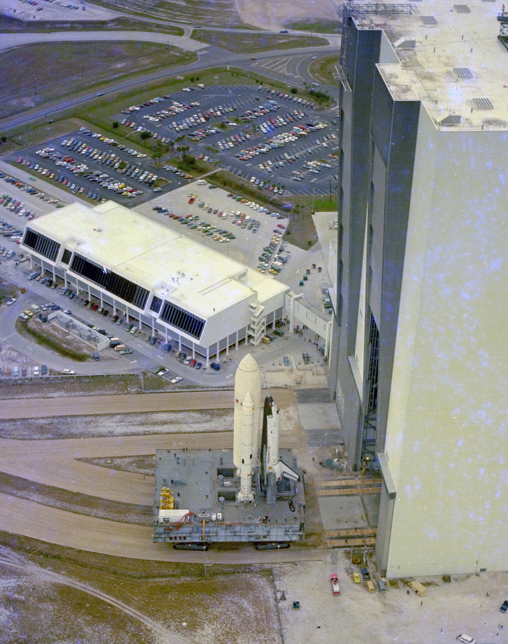 Space shuttle Columbia, the vehicle for the first space shuttle mission, moves out of the Vehicle Assembly Building for the 3.5-mile journey to Pad A at Launch Complex 39. 