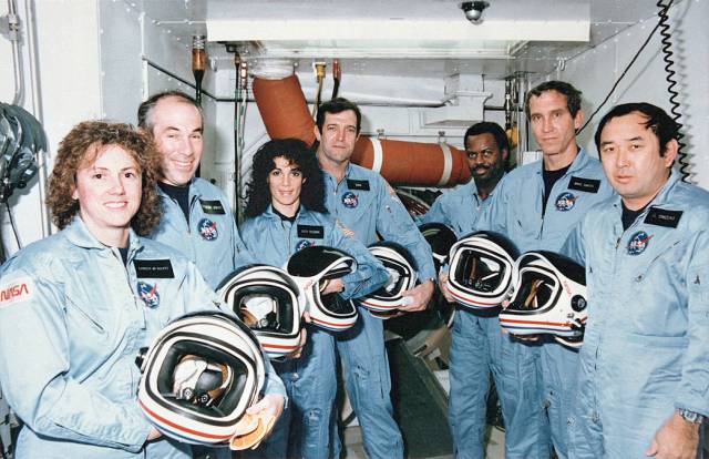 Crew members of mission STS-51L gather in the White Room at Pad 39B following the end of the Terminal Countdown Demonstration Test.