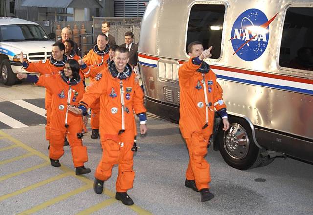 The STS-107 crew heads for the Astrovan and a ride to Launch Pad 39A for liftoff.
