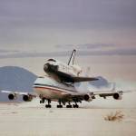 With Space Shuttle Columbia mounted firmly atop, NASA's modified Boeing 747 Shuttle Carrier Aircraft 905 kicks up clouds of gyps
