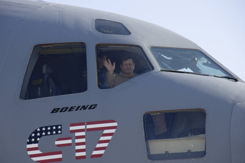 NASA Research Test Pilot Frank Batteas waves from the right-hand seat in the flight deck of U.S. Air Force C-17.