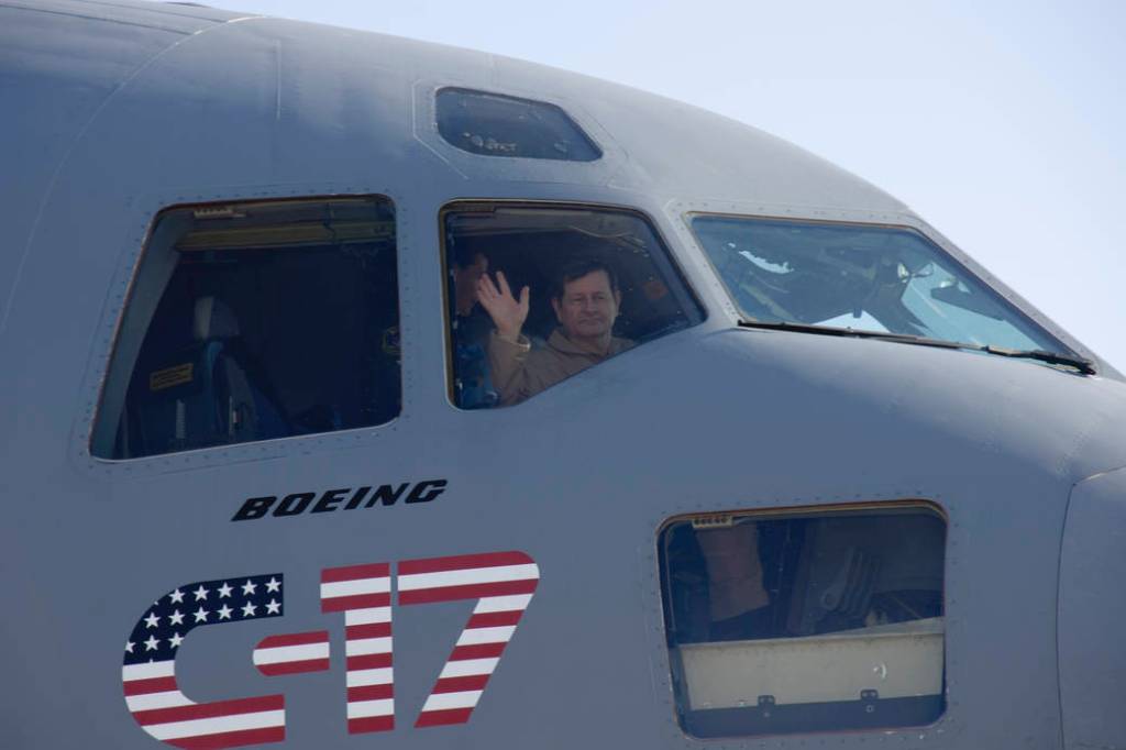 NASA Research Test Pilot Frank Batteas waves from the right-hand seat in the flight deck of U.S. Air Force C-17.