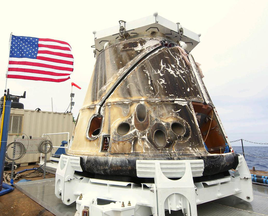 SpaceX Dragon capsule after splashdown on barge