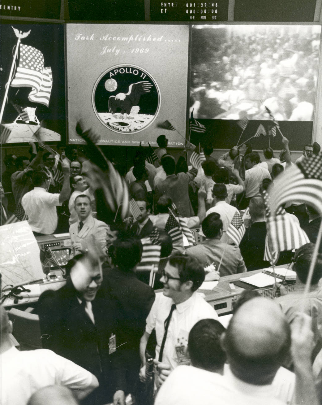 Celebration and waving American flags at Mission Control after Apollo 11 splashdown