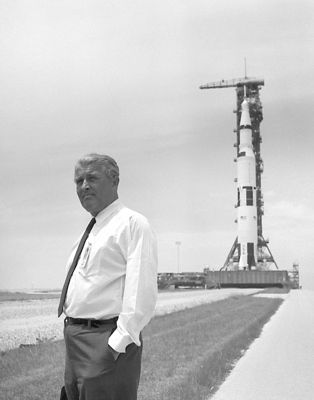 Dr. Wernher von Braun pauses in front of the Saturn V vehicle being readied for the historic Apollo 11 lunar landing mission. 