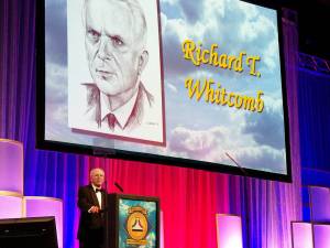 A man at the podium during the Richard T. Whitcomb induction into the National Aviation Hall of Fame.