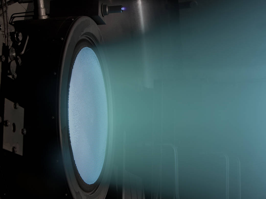 Blue circular end of engine with jets firing out