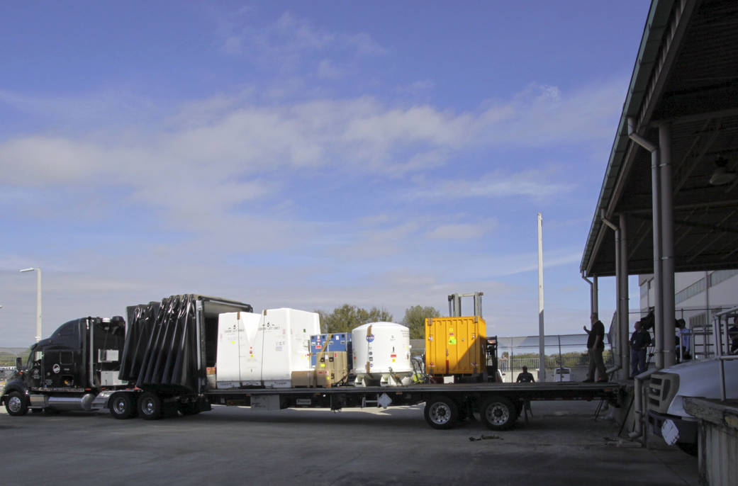 The shipping containers for the HTV-4 payloads are loaded for transport to Chicago.