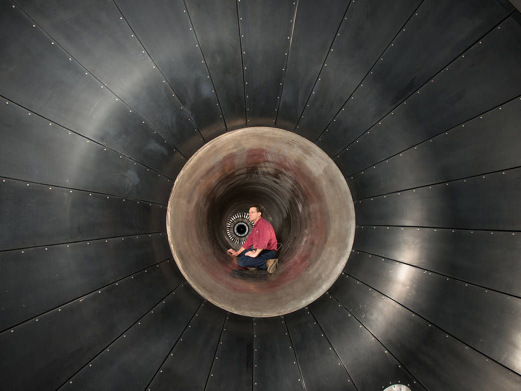 John Wargo performing an inspection on the inlet ducting, upstream of the Honeywell ALF 502 engine.