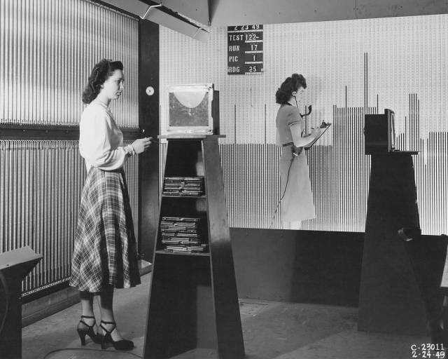 Woman working at manometer boards in the 18 x 18 inch Supersonic Wind Tunnel