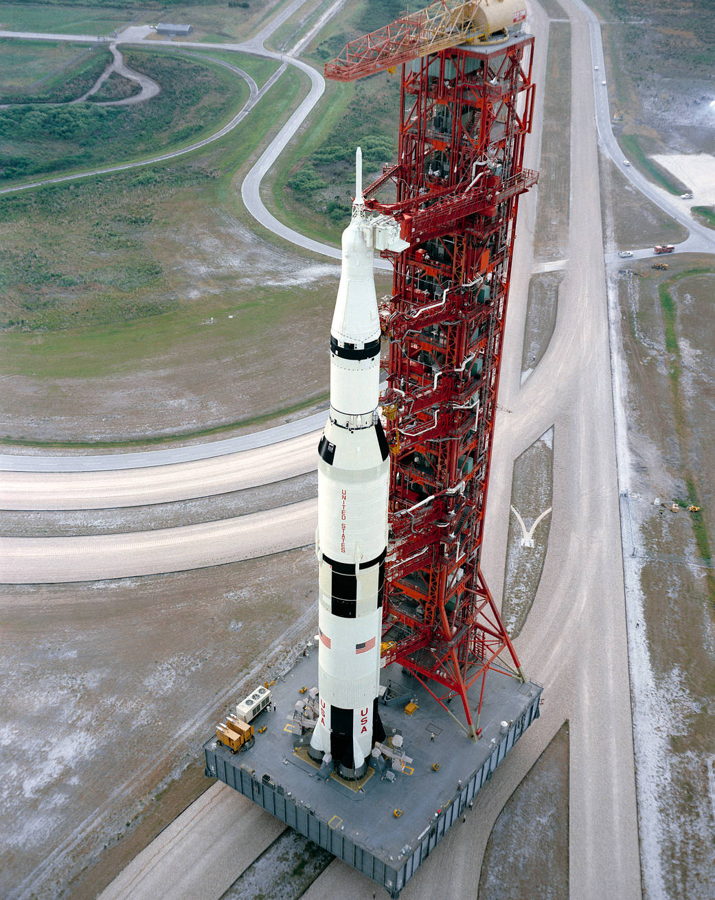 View of the Apollo 15 spacecraft on the Saturn V rocket being rolled out to the launchpad.