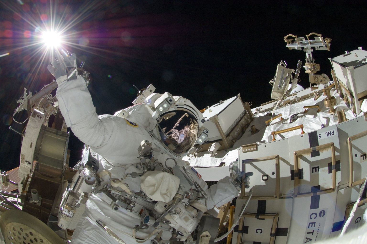 NASA astronaut Sunita Williams, Expedition 32 flight engineer, appears to touch the bright sun during the mission's third session of extravehicular activity (EVA).