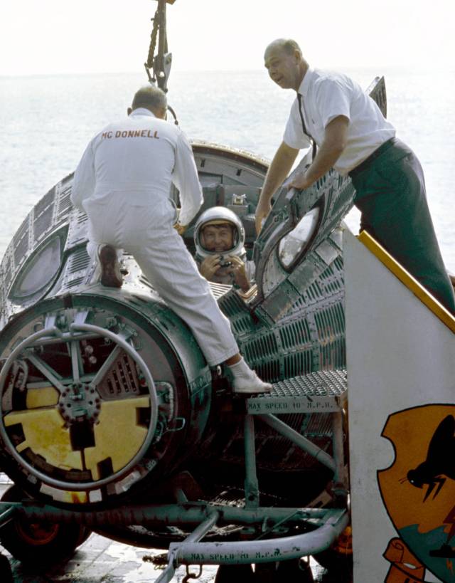 Gemini VI command pilot Wally Schirra climbs from his spacecraft 