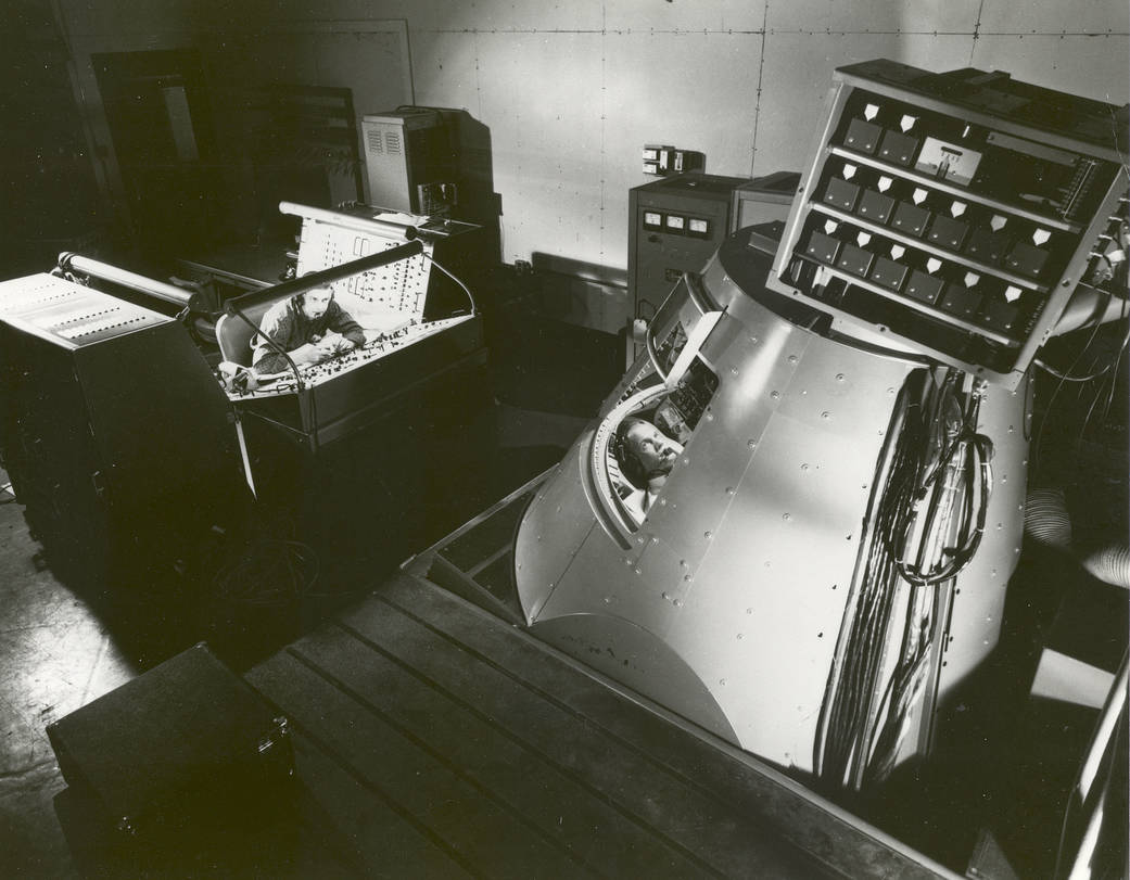 John Glenn in the Mercury Procedures Trainer, a spacecraft simulator