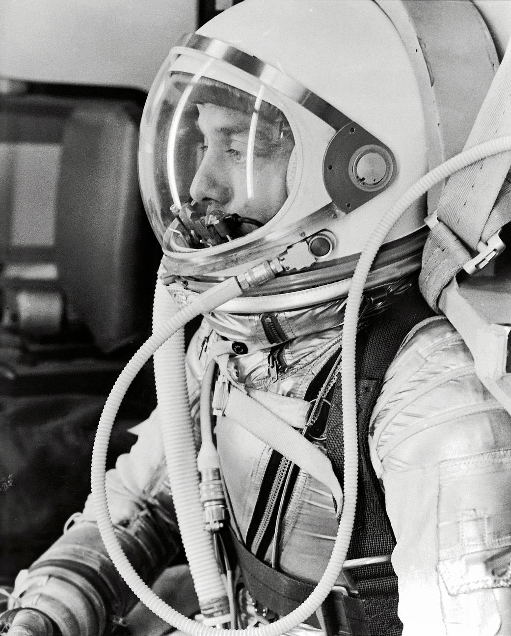 Side profile closeup photo of astronaut Alan Shepard in pressure suit with helmet