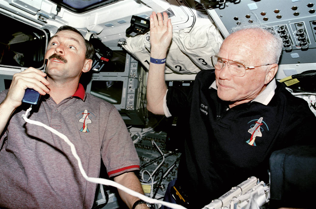 NASA astronaut Curtis Brown and John Glenn aboard shuttle Discovery