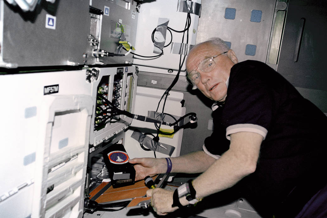 Astronaut John Glenn on middeck of shuttle Discovery