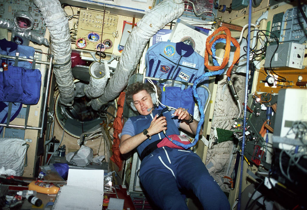 Astronaut Shannon W. Lucid communicates with the ground support team inside the Core Module of the Russian Mir Space Station.