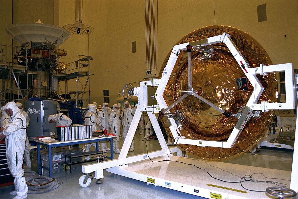 The Huygens probe is installed into the Cassini orbiter in the Payload Hazardous Servicing Facility at Kennedy Space Center.