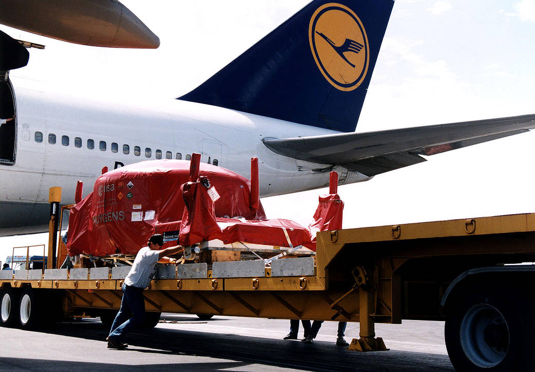 The Huygens probe is off-loaded from a plane at the Skid Strip runway on Cape Canaveral Air Force Station in Florida.