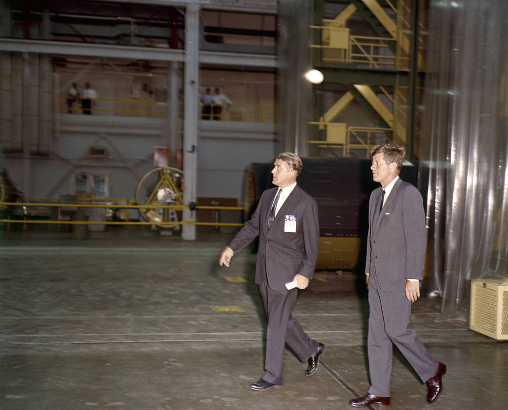President Kennedy and Dr. von Braun walk through building at NASA Marshall