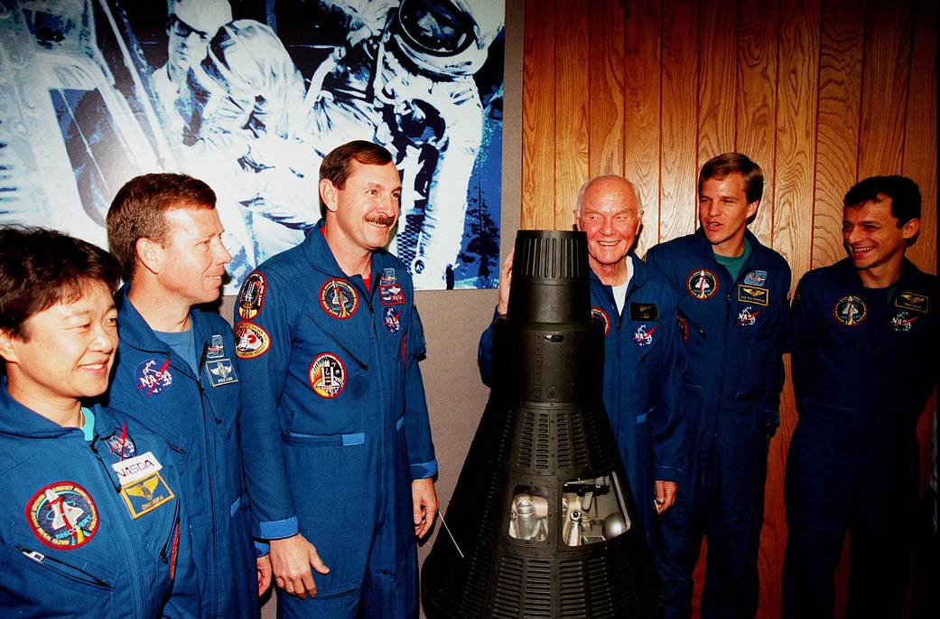 Shuttle crew members with Mercury capsule module