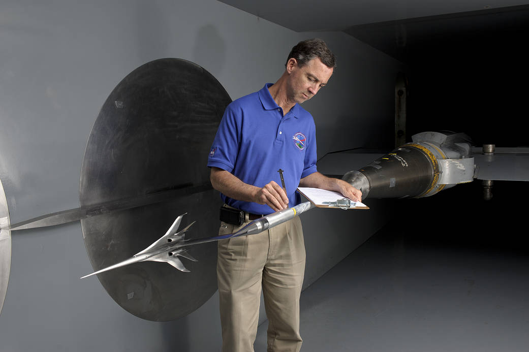 Researcher Don Durston inspects the mounting hardware for the 16-inch scale model of the Boeing concept.