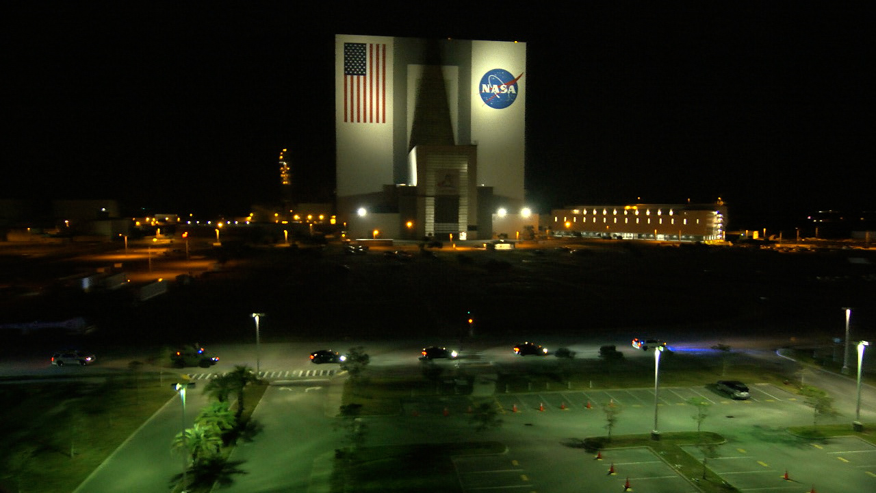 NASA's SpaceX Crew-6 flight crew in their SpaceX vehicles near the Vehicle Assembly Building