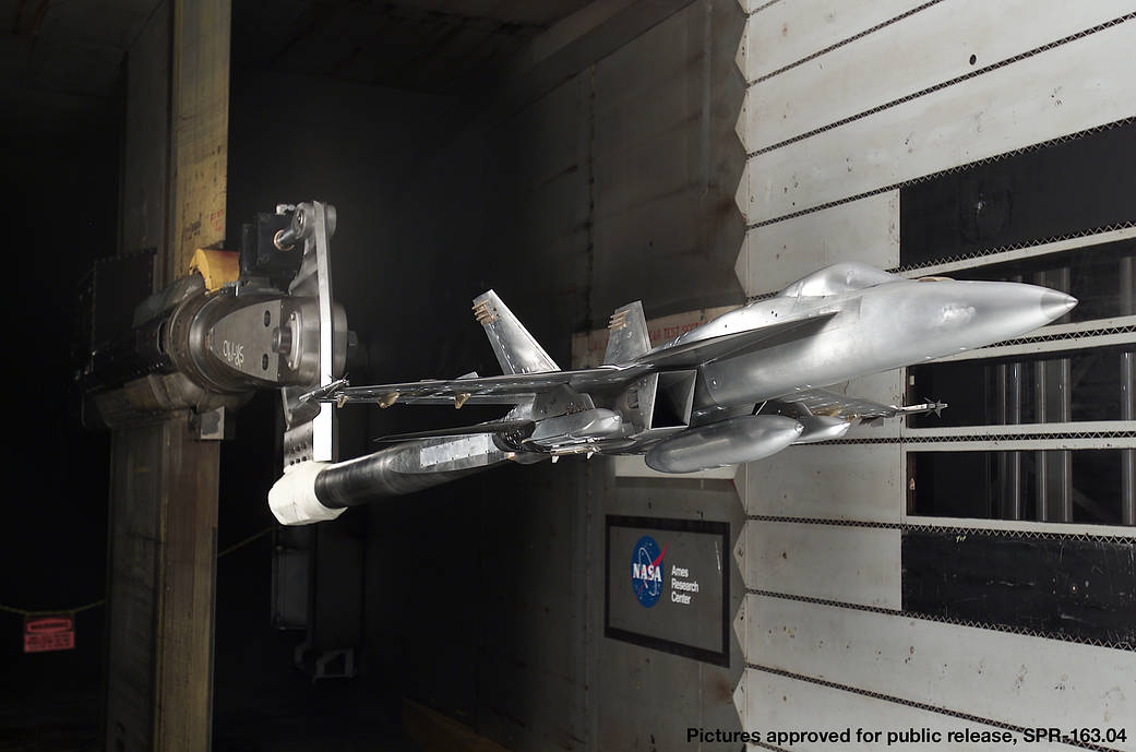 model of F-18 jet mounted in wind tunnel