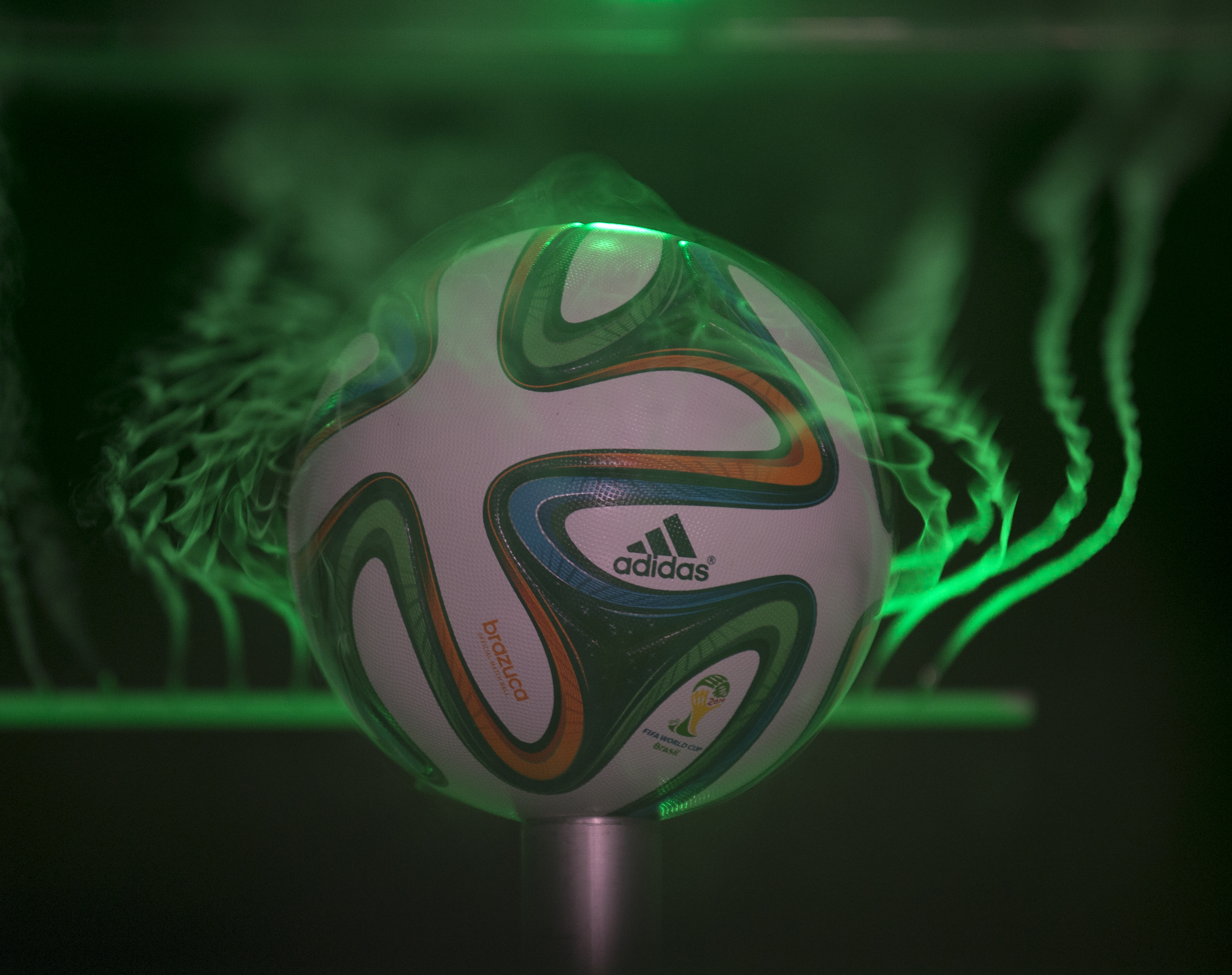soccer ball in a water chamber with lasers around soccer ball