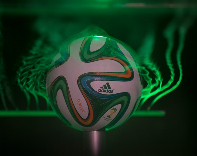 soccer ball in a water chamber with lasers around soccer ball